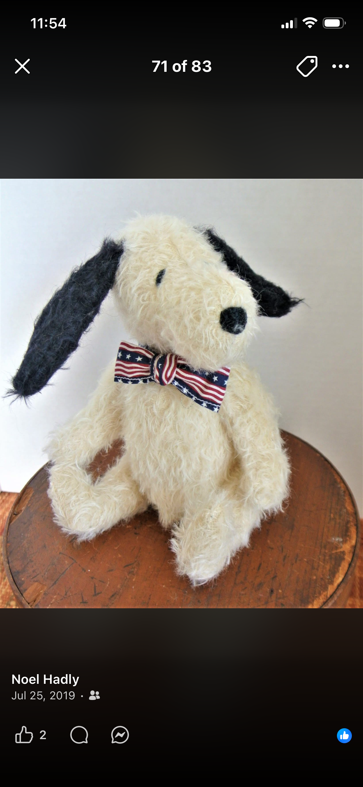 Handmade white dog character wearing a patriotic bow