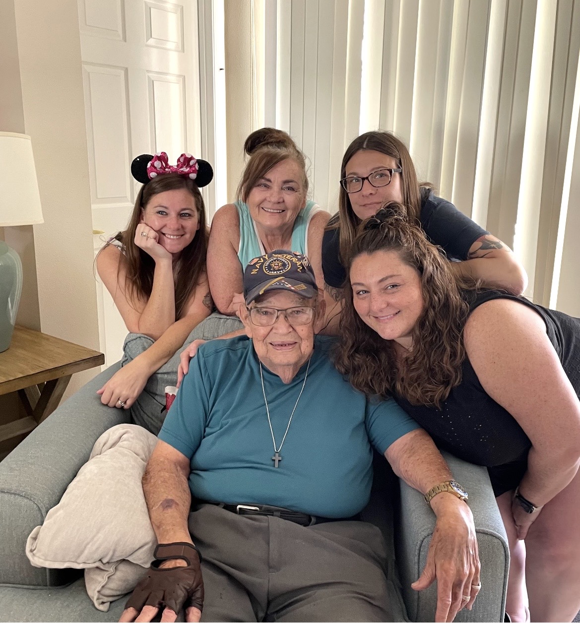 Jay seated with four family members gathered close